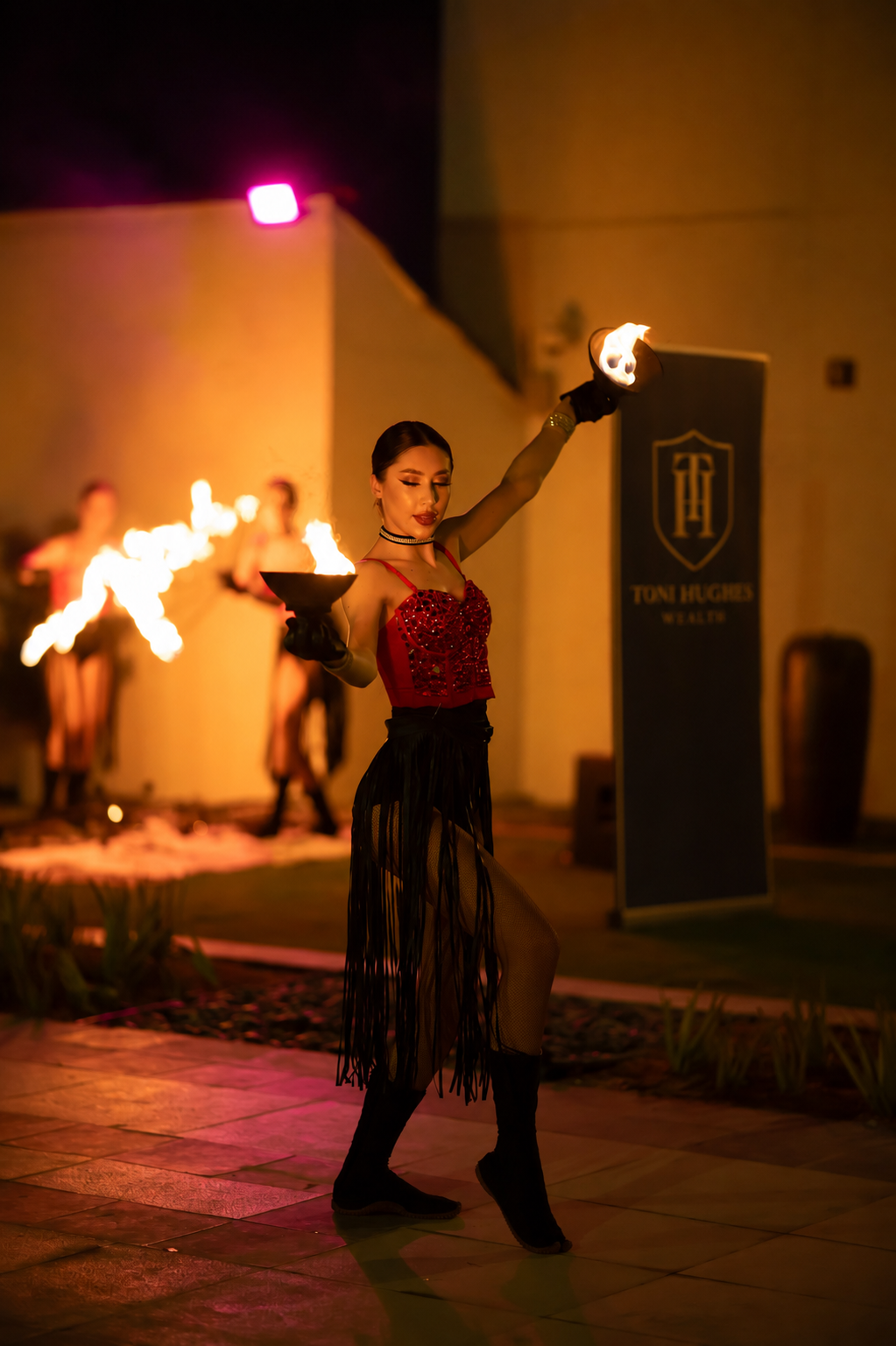 A fire performer at a private evening event